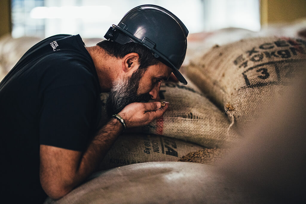 man_smelling_coffee_beans