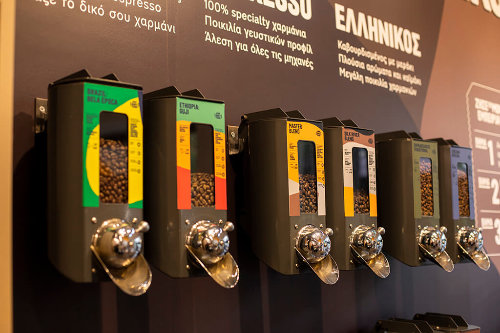 Coffee mills filled with coffee beans inside a coffee island store