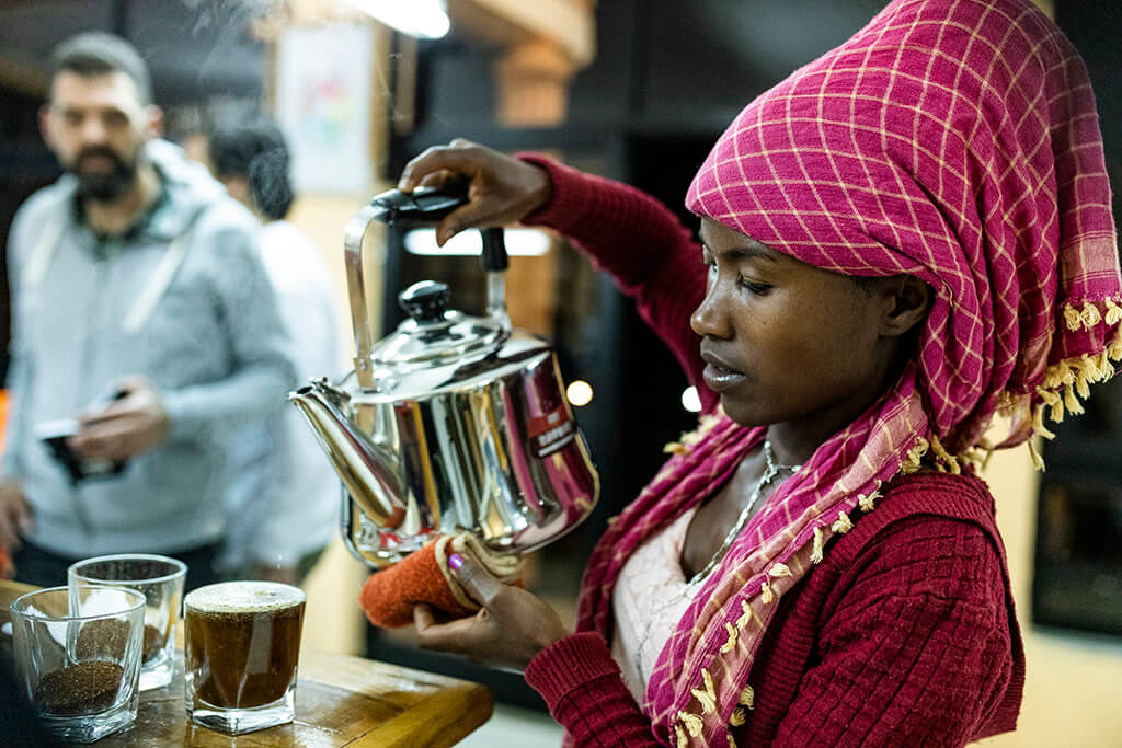Coffee Island International Women's Day, Ethiopian woman serving coffee.